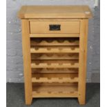 A light oak wine rack with drawer.