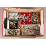 A box of costume jewellery. Including Police link bracelet, buttons, beads, etc.