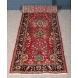 A vintage red ground fine woven Persian Kashan runner. Floral design. (303cm x 85cm).