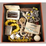 A box of mostly costume jewellery. Including Bluebird brooches, Ronson lighter, vesta, paw brooch,