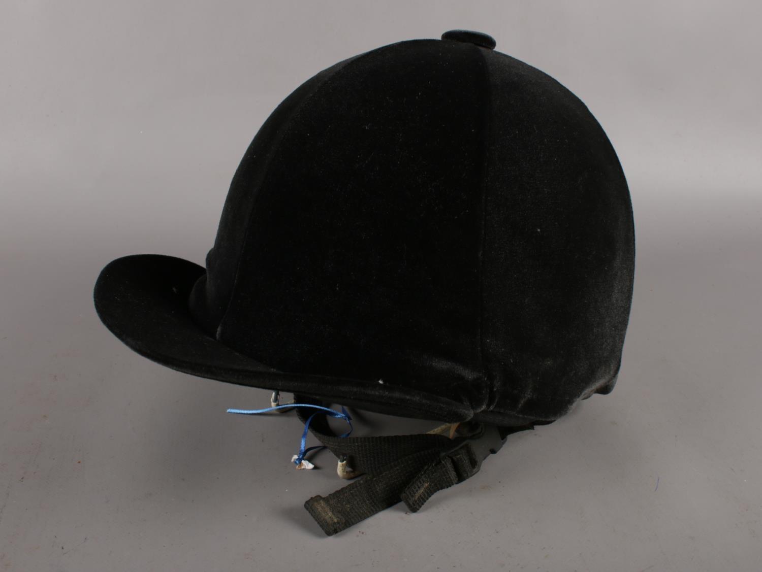 A Competitor horse riding helmet with fibre glass frame and velvet cover. (2-57).