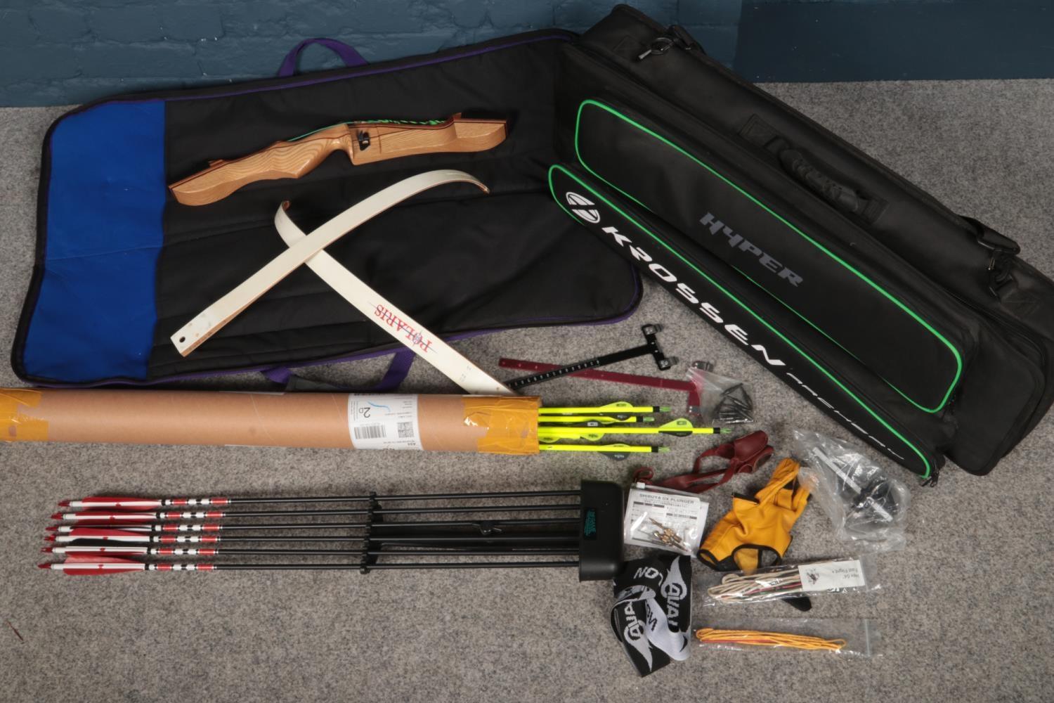 A Samick archery bow with a collection of arrows and related accessories.