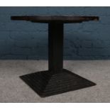 A coffee / occasional table with wooden circular top and iron stepped base. H: 48cm, Diameter: 60cm.