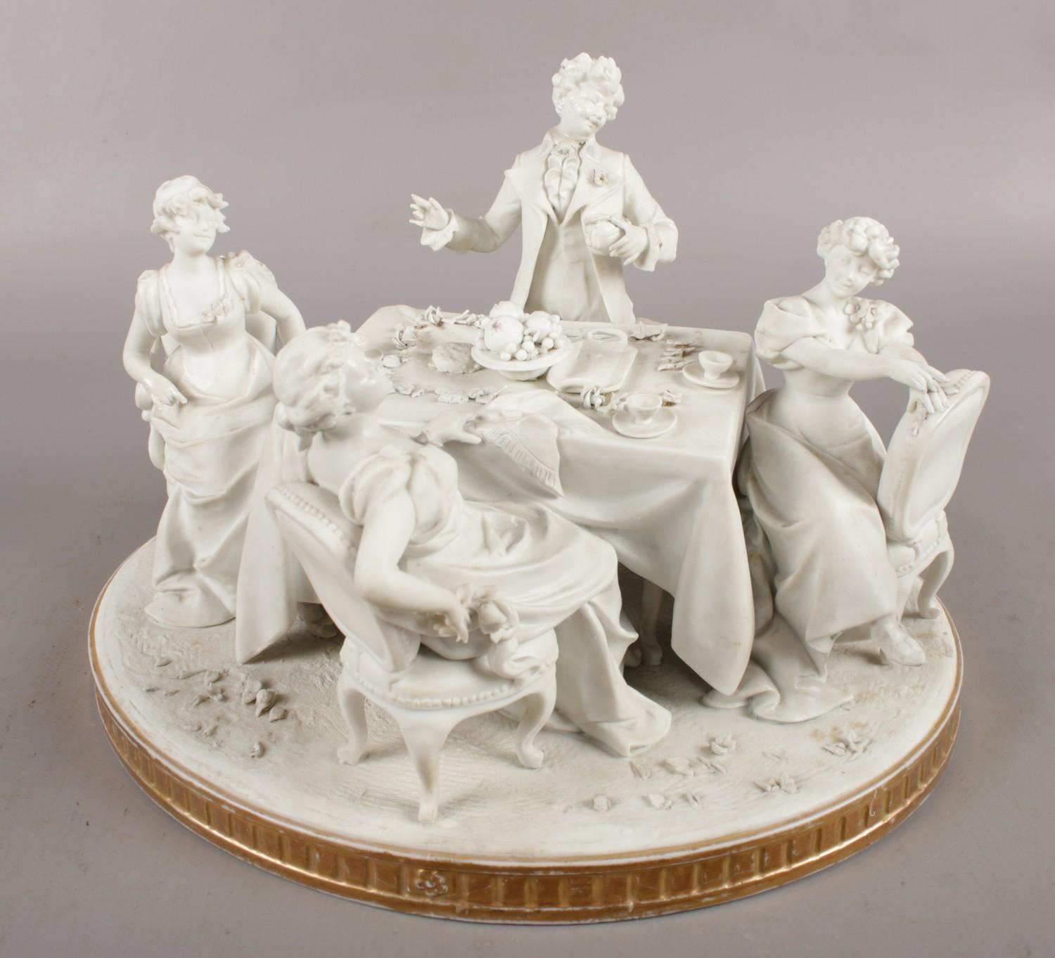 An early Sevres style bisque figure group depicting a dinner party, bearing inverted L symbol to