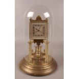 A German brass torsion clock under glass dome. (31cm).