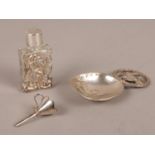 A silver caddy spoon with import marks along with a silver cased scent bottle and small silver