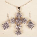 A silver tanzanite cross pendant and matching earrings.