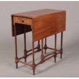 A 19th century mahogany gateleg spider table with single drawer. With slender turned supports and