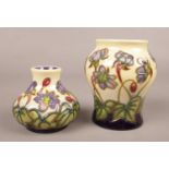 Two modern Moorcroft miniature vases in 'Hepatica' pattern by Emma Bossoms, boxed. H:9cm & H:6cm.