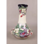 A Moorcroft 'Snowberry' vase, designed by Nicola Slaney. This vase has crazing. H:20.5cm, W:15cm.