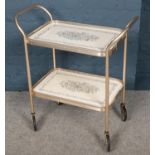 A two tier tea trolley.