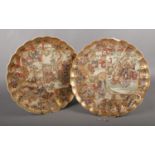 A pair of Japanese Satsuma plates, decorated with Samurai. (Diameter 31.5cm). Chips and repair to