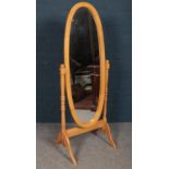 A full length wooden oval dressing mirror. Total height-155cm, width-63cm, depth- 47cm. Condition