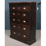 A stained pitch pine chest of five drawers with oak top and brass cup handles. (113cm x 83cm x 30cm)