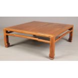 An early 20th century Chinese carved hardwood square low table, 89cm square, 32cm high.