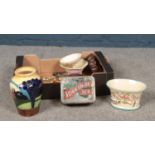 A box of miscellaneous. Ceramic vase, planters Falcon ware example. Yorkshire Tea Advertising tin,