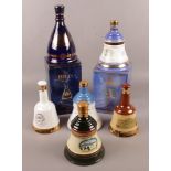 Two boxed full and sealed Bell's whiskey ceramic commemorative decanters along with four empty