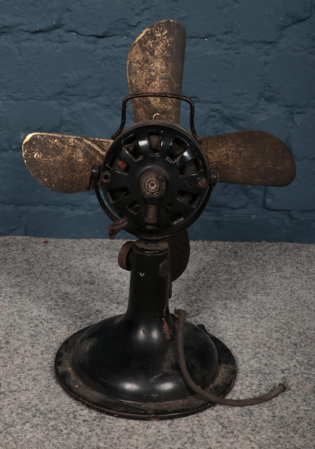 An early 20th century metal table fan. H: 40cm, W: 30cm. Please note that this fan will need a re- - Image 2 of 2