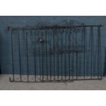 Two painted metal garden gates with scroll decoration. Height 90cm Width 93cm