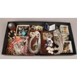 A tray of costume jewellery to include necklaces, bracelets, buttons, etc.