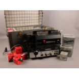 A Eumig 824 super 8 sonomatic projector in carry case, with collection of bulbs/lamps.