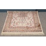 An ivory ground Kashmir rug. Medallion design. (170cm x 120cm).