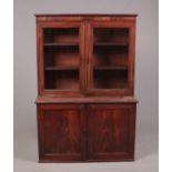 A Regency mahogany dwarf bookcase raised over a two door cupboard base, 150cm height 103cm width
