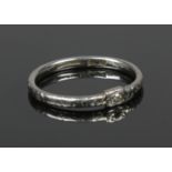A platinum ring set with a single diamond. With chased decoration. Size P, 3.51g.