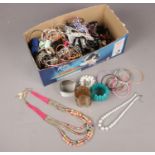 A collection of costume jewellery. Beads, bangles, necklaces examples etc.