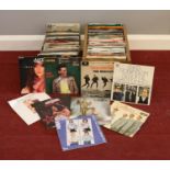A collection of 45 rpm vinyl records. Frank Sinatra, The Beatles, Simon & Garfunkel, Erasure,