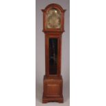 A carved Edwardian mahogany longcase clock. With brass and roman numeral markers dial. The