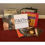 A collection of vinyl LP records. Kate Bush, The Rolling Stones, Buddy Holly, George Michael