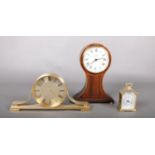 A collection of three clocks - comprising of a 'Churchill' Quartz brass mantle clock, a 'Comitti' of