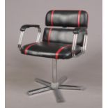 A black and red designer swivel arm chair, with chrome base. Material is leatherette.