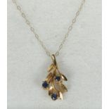 A 9ct gold and sapphire pendant on chain.