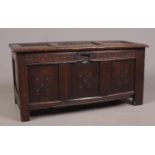 A period oak carved and panelled coffer. (57cm height 46cm depth 117cm width) Split to centre top