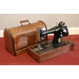 An oak cased Singer sewing machine. With key.