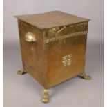 An Arts & Crafts hammered brass coal scuttle.