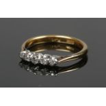 An 18ct gold and platinum five stone diamond ring. Size O, 3.32g.