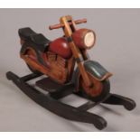 A painted hardwood rocking motorbike. H:63cm, L:97cm, D:33cm. Condition good. Slight paint scuffs.