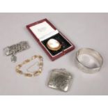 A collection of jewellery. Includes cameo brooch, silver bangle, yellow metal and white metal