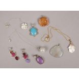 A collection of silver jewellery, mainly pendants. Includes two silver chains and a silver gilt