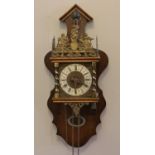 A United Clockworks, made in Holland wall clock, mahogany case with brass figural decoration,