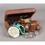A wooden carved jewellery box. Including a collection of costume jewellery, beads, necklaces, quartz