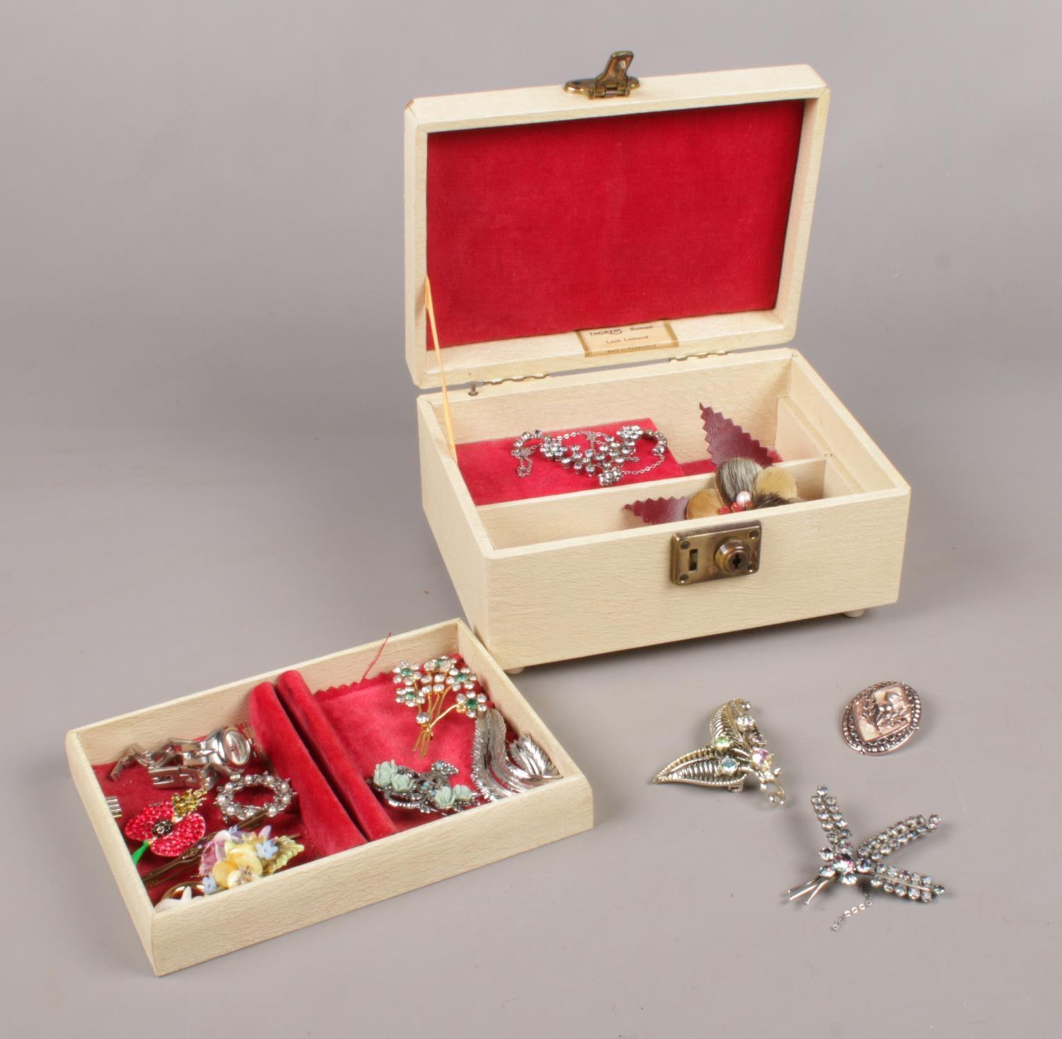 A Vintage Thoren's musical jewellery box. To include various brooches.