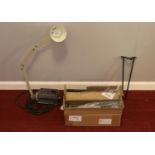 A vintage industrial articulated work light and a box of nine hair pin metal legs. The light is