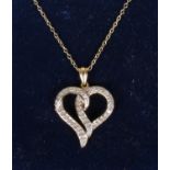 A 9ct gold and diamond heart shaped pendant on chain.