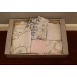 A box of vintage linen. Tablecloths, napkins examples etc.