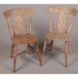 A pair of hardwood kitchen chairs.