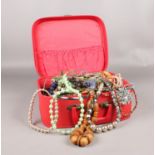 A collection of costume jewellery. Beads, bangles, necklaces in a vanity case.